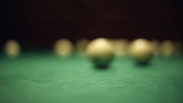 Billiards table and balls, strike the cue ball and breaking the pyramid
