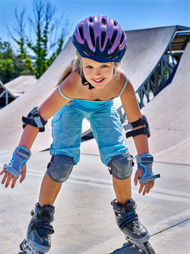Fun active sports girl riding on roller skates in skatepark.