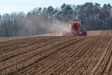 Tractor harrowing the field