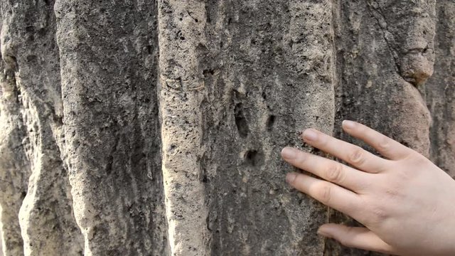 hand touching an ancient column as concept of love to historical architecture