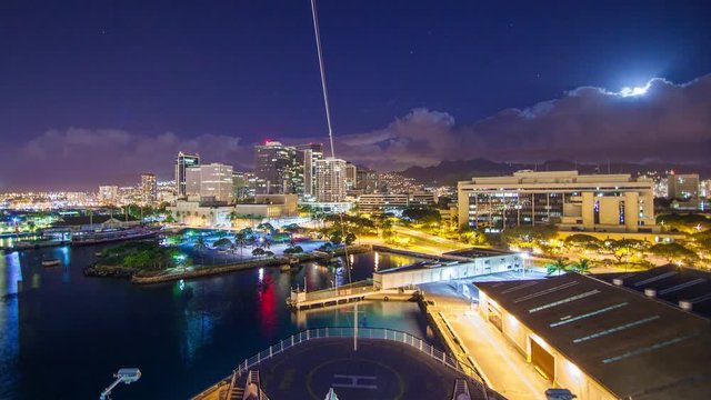 Cruise Ship Departing Honolulu Hawaii at Night Timelapse with Fast Movement from the City Lights Buildings Traffic and Moon Lit Clouds