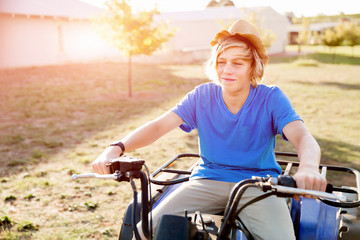 Boy riding farm truck in vineyard