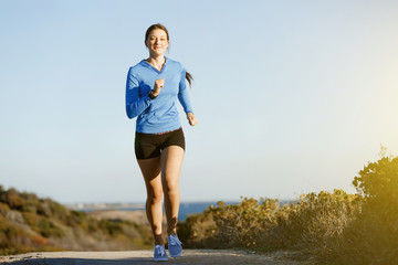 Sport runner jogging on beach working out