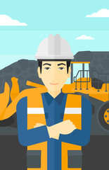 Miner with mining equipment on background.