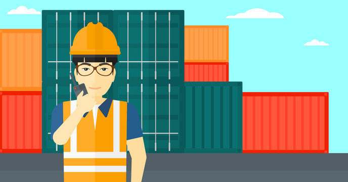 Stevedore standing on cargo containers background.