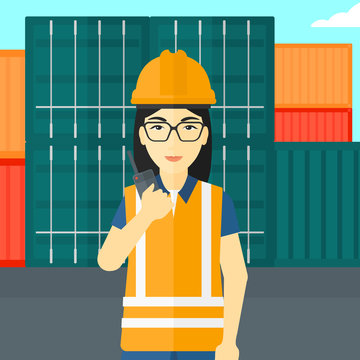 Stevedore standing on cargo containers background.