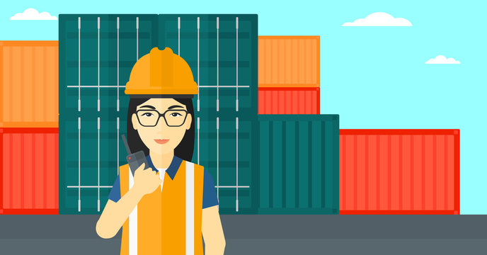 Stevedore standing on cargo containers background.