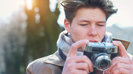 Attractive Tourist taking a photograph with vintage camera