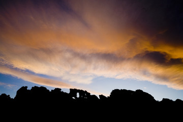 The sun sets behind The Keystone, a natural rock arch at Devil's Backbone Open Space in Loveland, Colorado.