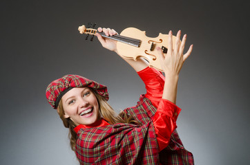 Woman in scottish clothing in musical concept