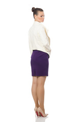 Fototapeta premium Pretty model wearing purple dress isolated on white