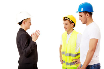 Female engineer talking with two builders