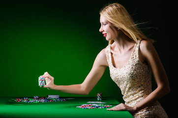 Young woman in casino gambling concept
