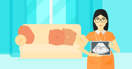 Pregnant woman with ultrasound image.