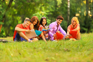 Fototapeta premium group of happy students with books in the Park on a Sunny day