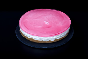 Fresh homemade cheesecake with pink jelly