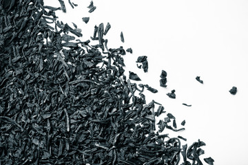 Dry black tea leaves as texture for background. Toned