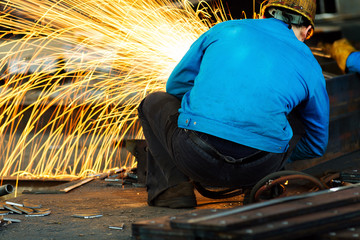 Worker cutting steel