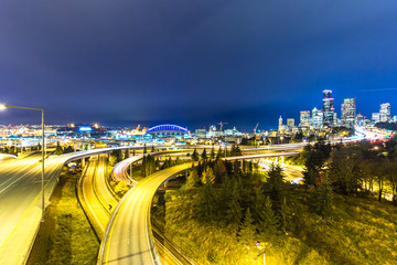 traffic on road with cityscape and skyline of seattle at twiligh