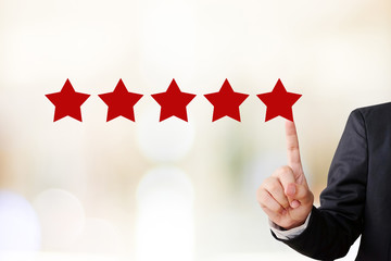 Businessman hand pointing five star