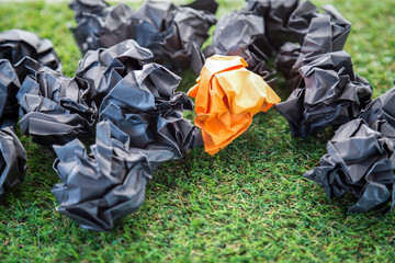 orange and black trash paper balls