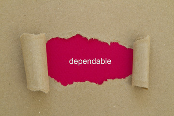 Dependable word written under torn paper.