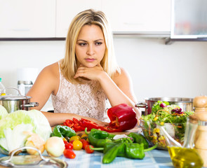 Confused housewife in the kitchen