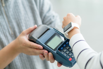 Woman using smart watch to pay