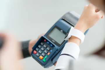 Woman using smart watch to pay