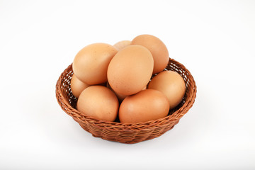 whole brown eggs in a wicker basket