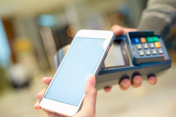Woman using mobile phone to pay