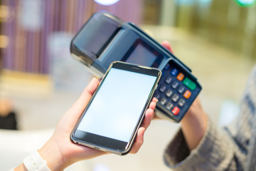 Woman using cellphone to checkout
