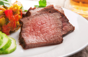 Pieces of roast beef on white plate