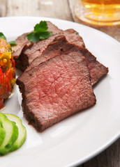 Pieces of roast beef on white plate