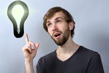 Young man with lightbulb having a good idea
