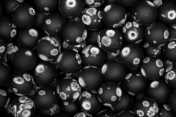 Black plastick beads. Hi res photo. Texture.
