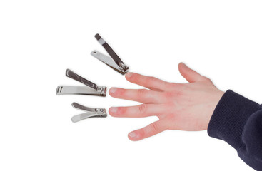 Three nail clippers opposite the fingers of a male hand