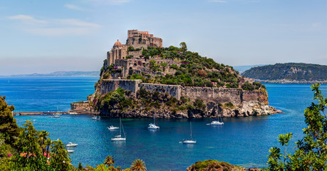 Aragon castle. Hieron I of Syracuse built the fortress in 474 B.C. In 1441 Alfonso of Aragon, rebuilt the old Castle, linking to the main island by the stone bridge. Ischia island, Italy. - obrazy, fototapety, plakaty