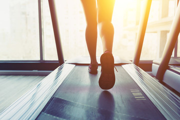 Fitness girl running on treadmill
