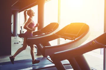 Foto op Canvas Fitness girl running on treadmill © arthurhidden
