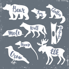 Wild animals isolated silhouettes with lettering: bear, frog, glutton, wolf, mole, mouse, woodpecker, mouse, crow, elk. Vector illustration.