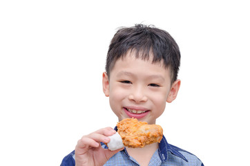Young Asian boy eating fried chicken over white