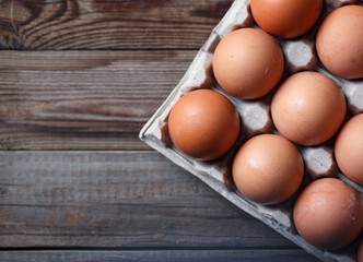 Brown eggs on a rustic wooden table