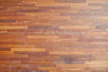 Brown wood background. Leaflets are arranged in a line