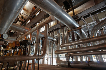Equipment, cables and piping as found inside of a modern industr