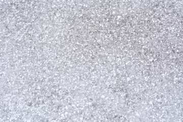 Background of fresh snowflakes on icy surface
