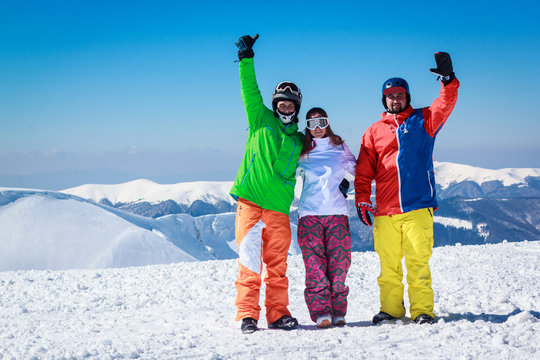 young cheerful people on a snowy mountain