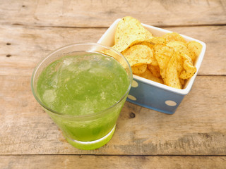 glass of apple juice and potato chips