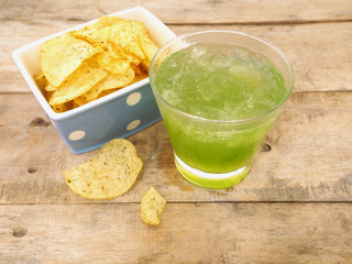 glass of apple juice and potato chips