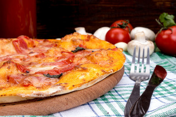 Margarita pizza with cheese and tomatoes on a wooden table